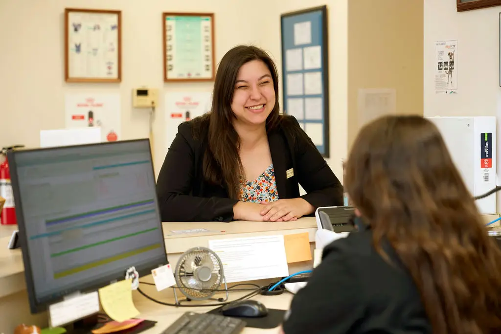Practice manager smiling at a staff member at the front desk at Dublin Animal Hospital